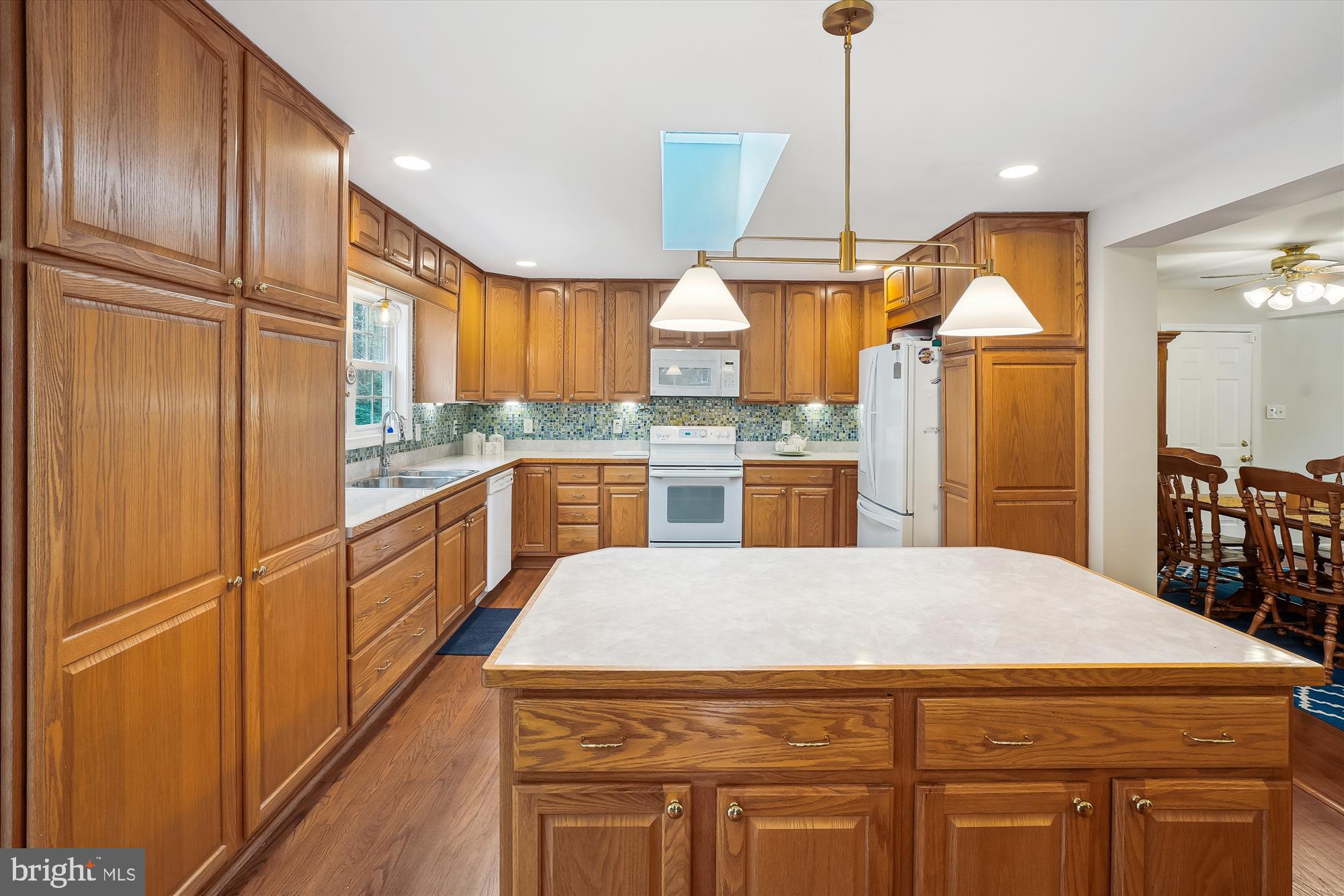 6957 Conservation Drive Springfield, VA 22153 - Photo 16 of 64 a kitchen with kitchen island a counter top space appliances and cabinets