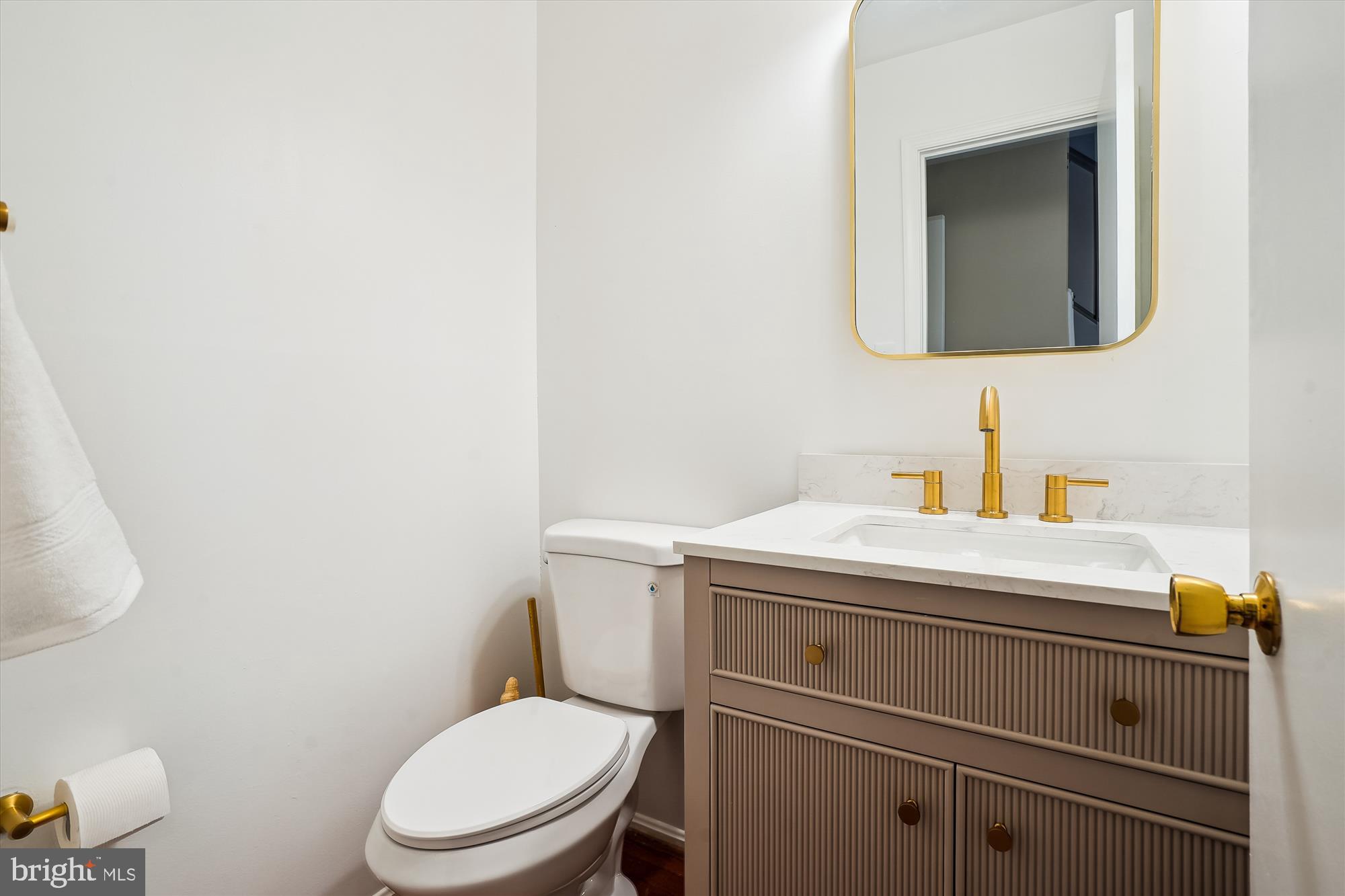 6957 Conservation Drive Springfield, VA 22153 - Photo 27 of 64 a bathroom with a toilet sink and mirror
