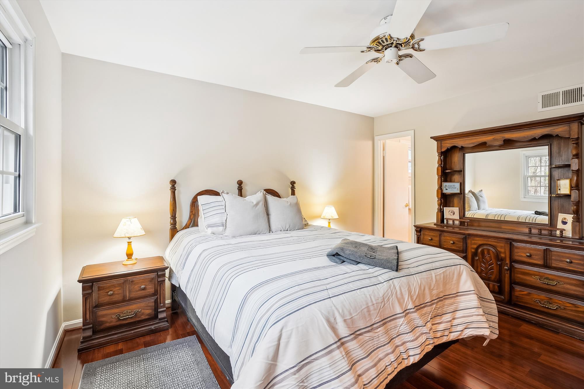 6957 Conservation Drive Springfield, VA 22153 - Photo 29 of 64 a bedroom with a bed and a chandelier