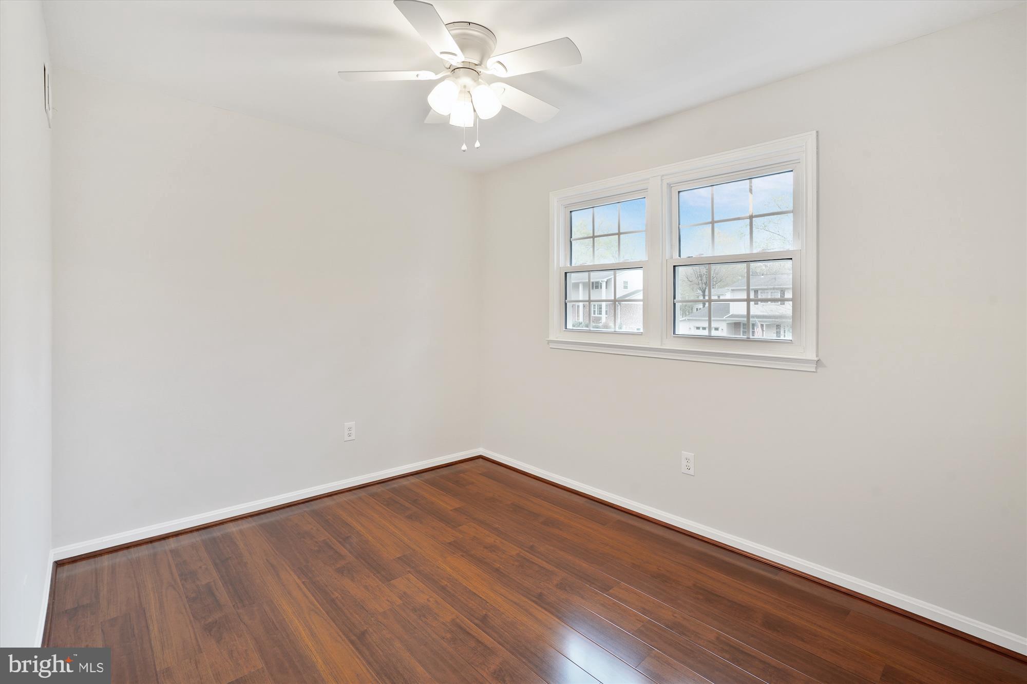6957 Conservation Drive Springfield, VA 22153 - Photo 33 of 64 an empty room with wooden floor and windows