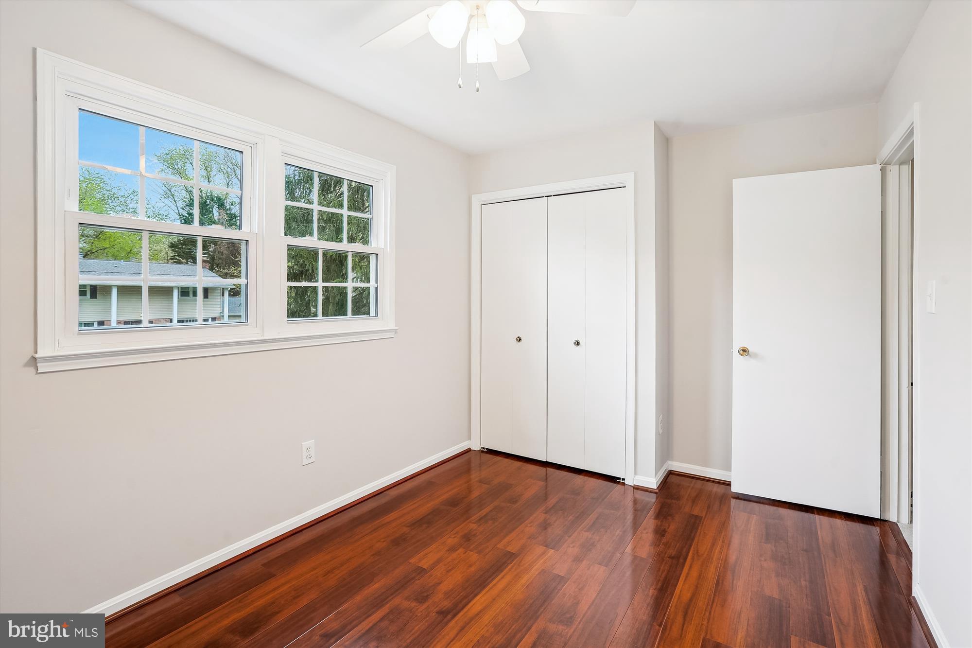 6957 Conservation Drive Springfield, VA 22153 - Photo 34 of 64 a view of an empty room with wooden floor and a window