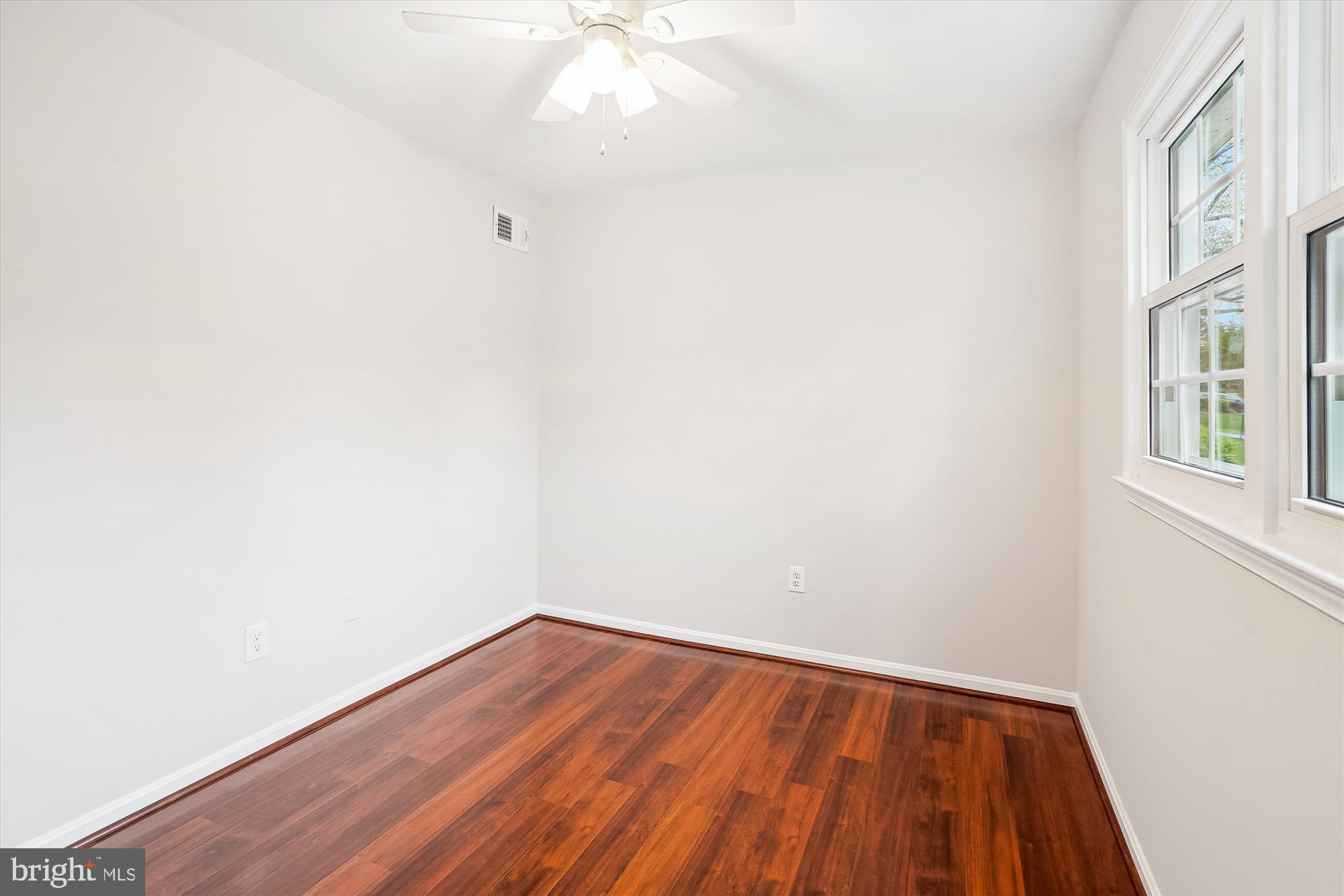 6957 Conservation Drive Springfield, VA 22153 - Photo 36 of 64 an empty room with wooden floor and windows