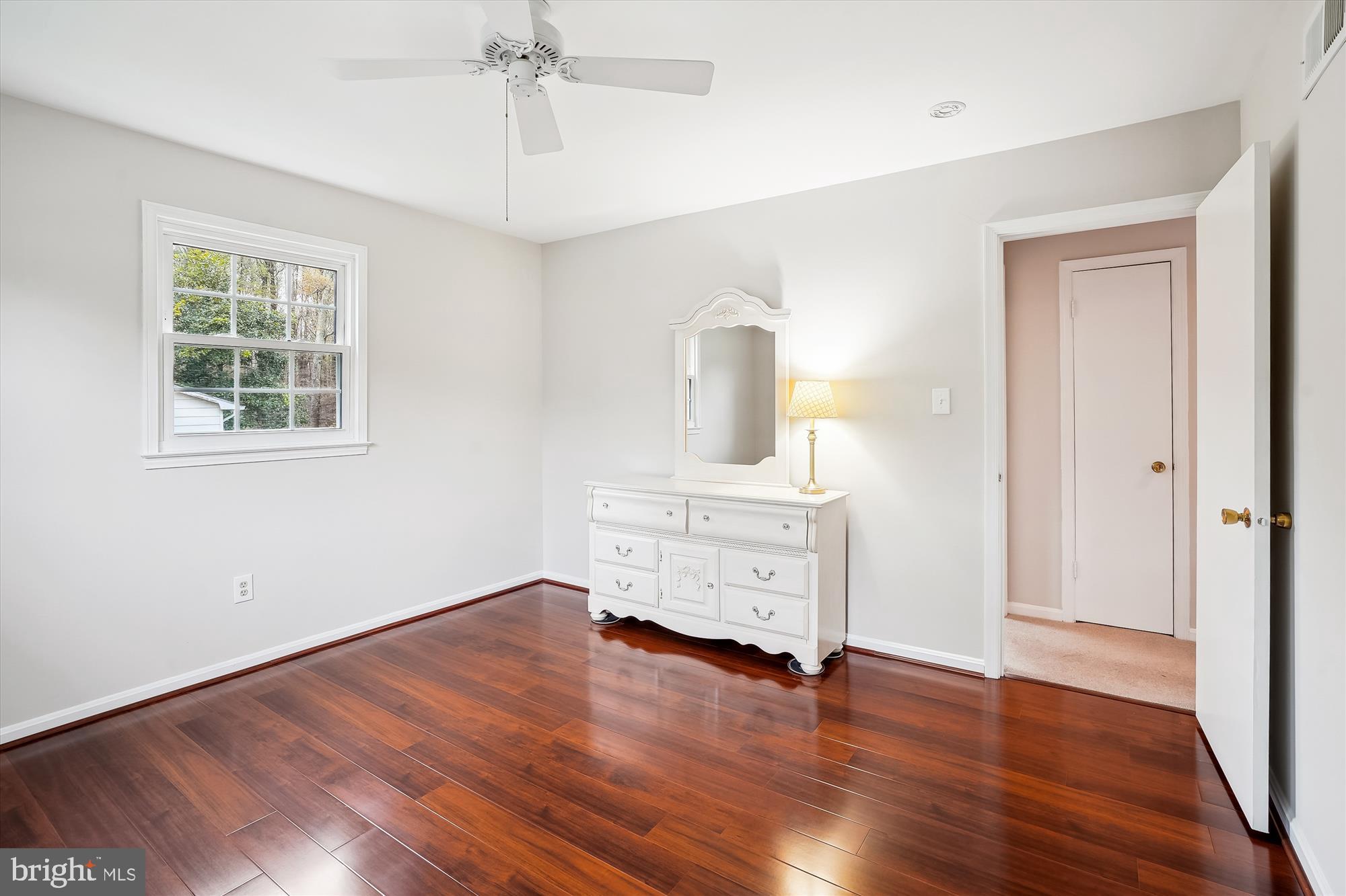 6957 Conservation Drive Springfield, VA 22153 - Photo 39 of 64 an empty room with wooden floor cabinet and windows