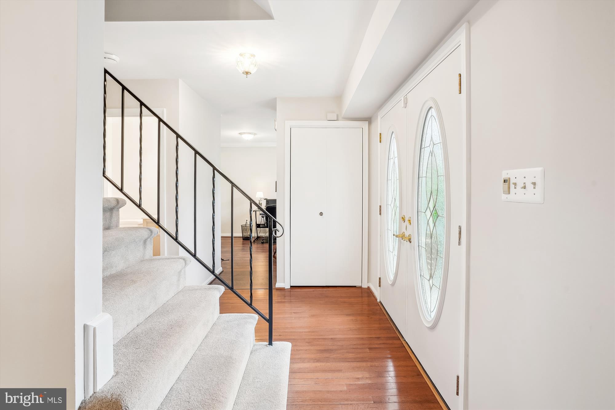6957 Conservation Drive Springfield, VA 22153 - Photo 5 of 64 a view of a hallway with wooden floor and entryway
