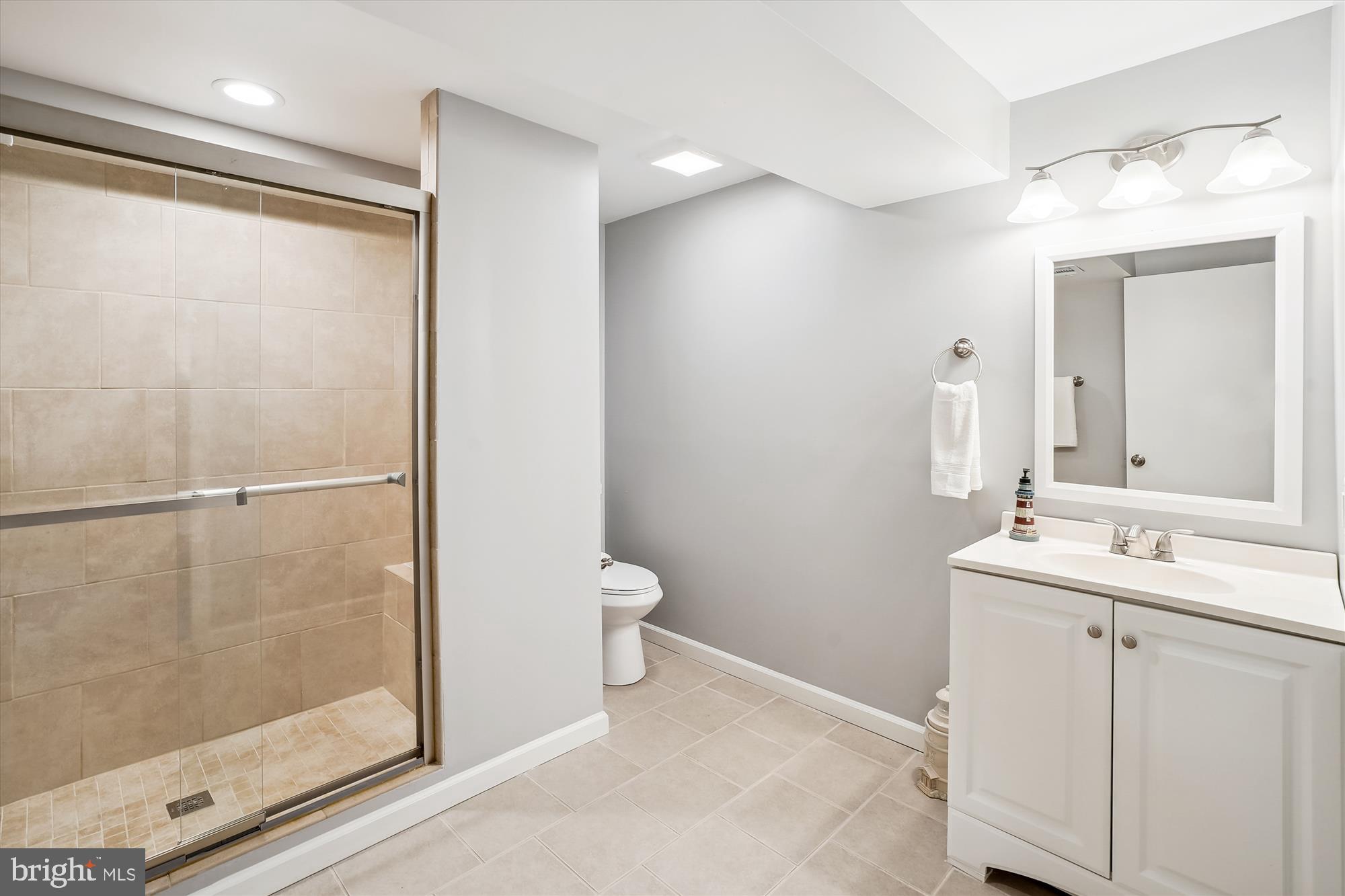 6957 Conservation Drive Springfield, VA 22153 - Photo 54 of 64 a bathroom with a shower sink and toilet