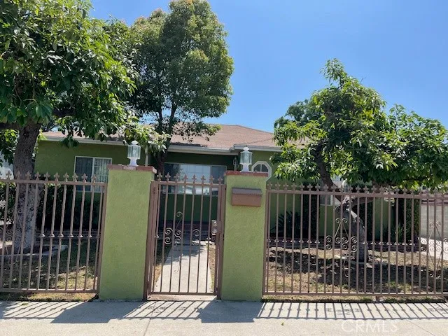 a view of a house with a iron gate