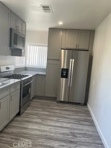 a kitchen with stainless steel appliances a refrigerator and a stove