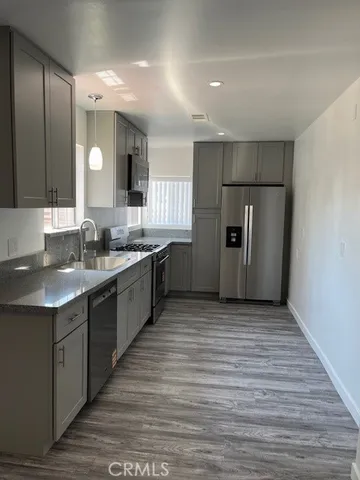 a kitchen with stainless steel appliances granite countertop a refrigerator and a sink
