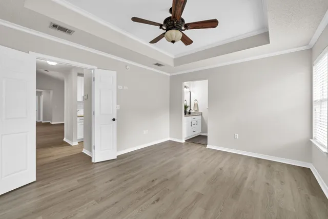 a view of a hallway with wooden floor