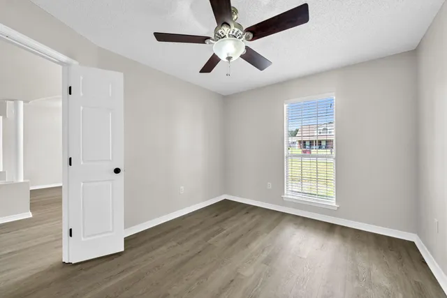 a view of a hallway with wooden floor