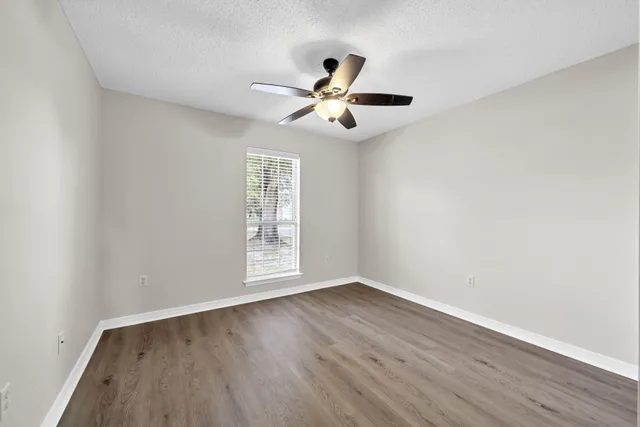a view of kitchen with wooden floor fan and a window