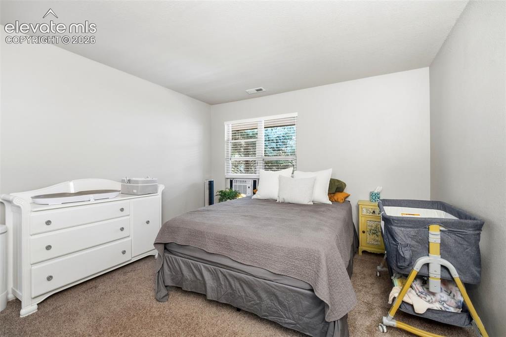 4357 Hunting Meadows Circle Colorado Springs, CO 80916 - Photo 9 of 20 a bedroom with a bed and a window