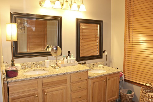 683 Sanders Road Macon, GA 31210 - Photo 8 of 19 a bathroom with a granite countertop sink and a mirror