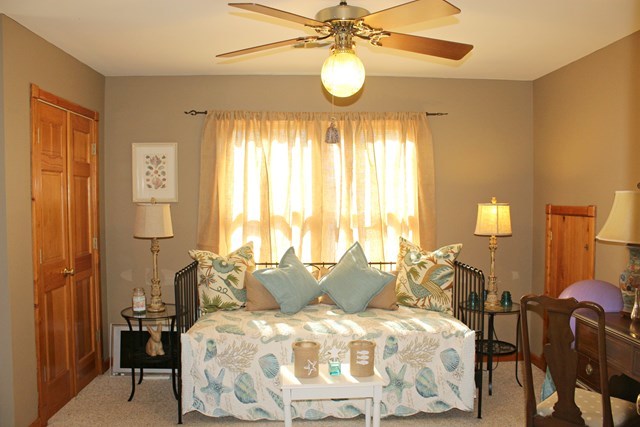 683 Sanders Road Macon, GA 31210 - Photo 10 of 19 a spacious bedroom with a bed and a chandelier