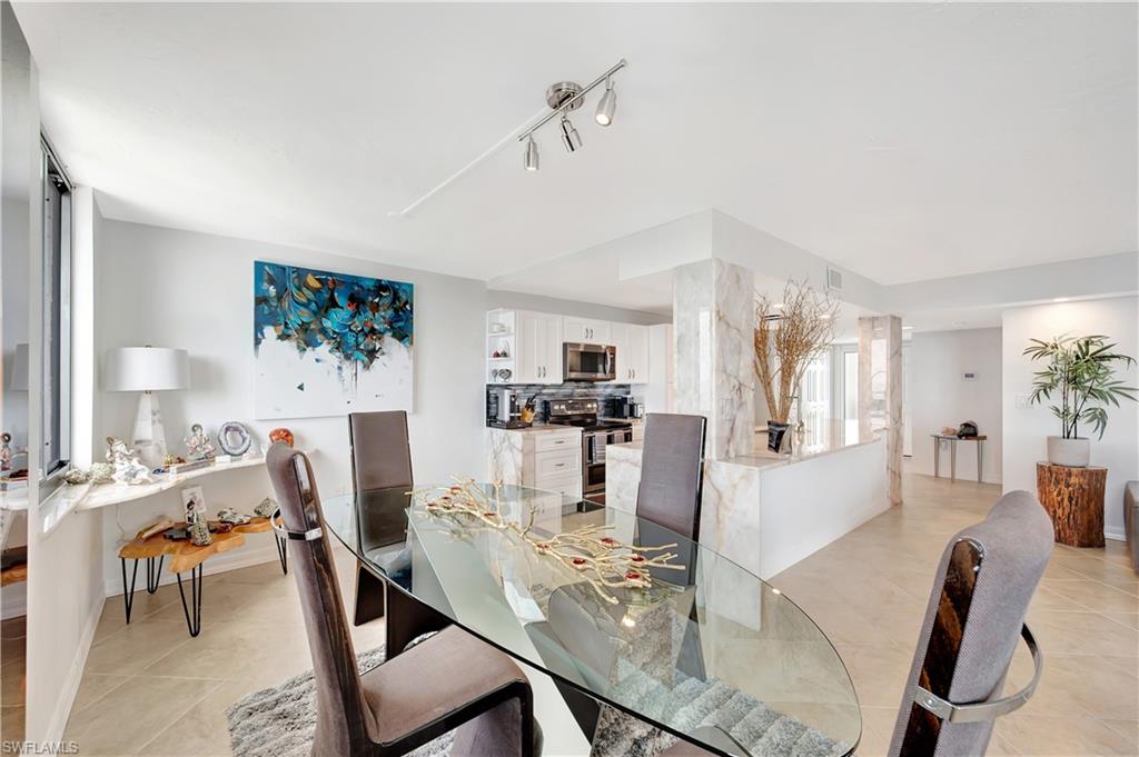 11 Bluebill Avenue, Unit 1101 Naples, FL 34108 - Photo 17 of 40 a view of a dining room with furniture