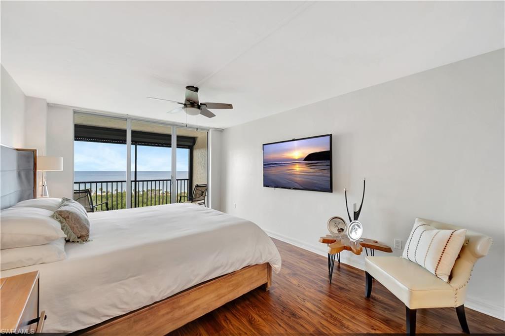 11 Bluebill Avenue, Unit 1101 Naples, FL 34108 - Photo 23 of 40 a bedroom with a bed and a flat screen tv