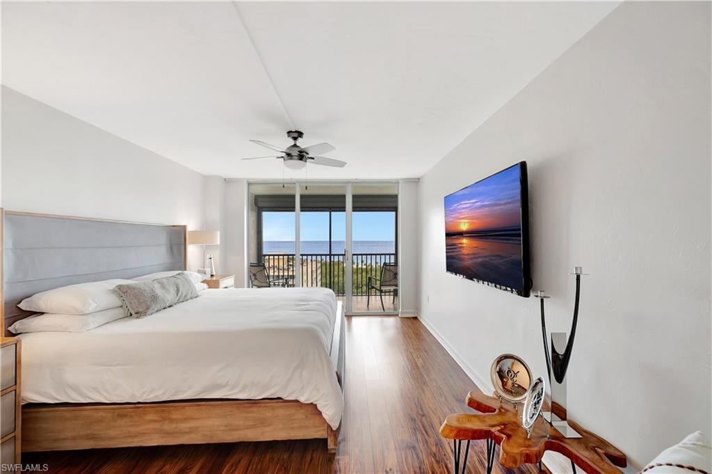 11 Bluebill Avenue, Unit 1101 Naples, FL 34108 - Photo 24 of 40 a bedroom with a bed and a flat screen tv