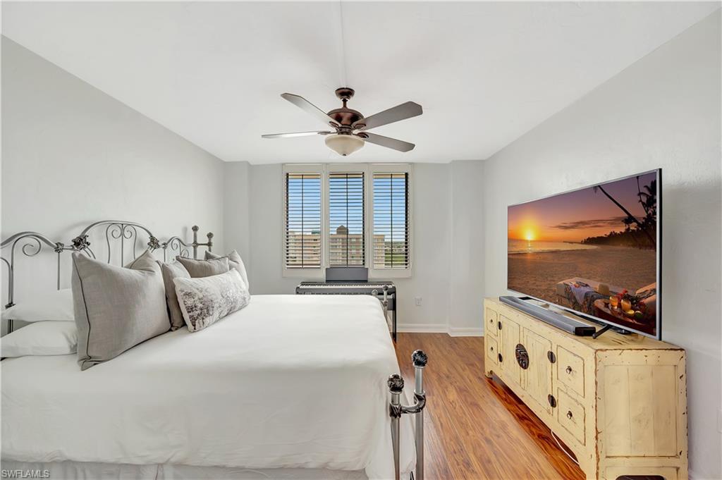 11 Bluebill Avenue, Unit 1101 Naples, FL 34108 - Photo 28 of 40 a bedroom with bed and a flat screen tv