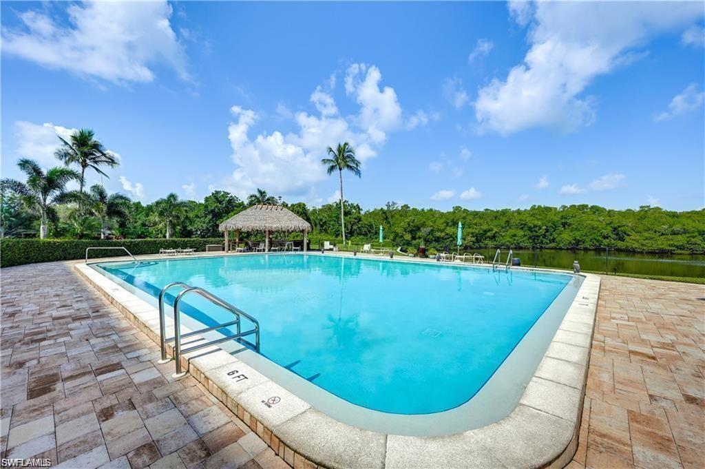 11 Bluebill Avenue, Unit 1101 Naples, FL 34108 - Photo 31 of 40 a view of a swimming pool with a yard
