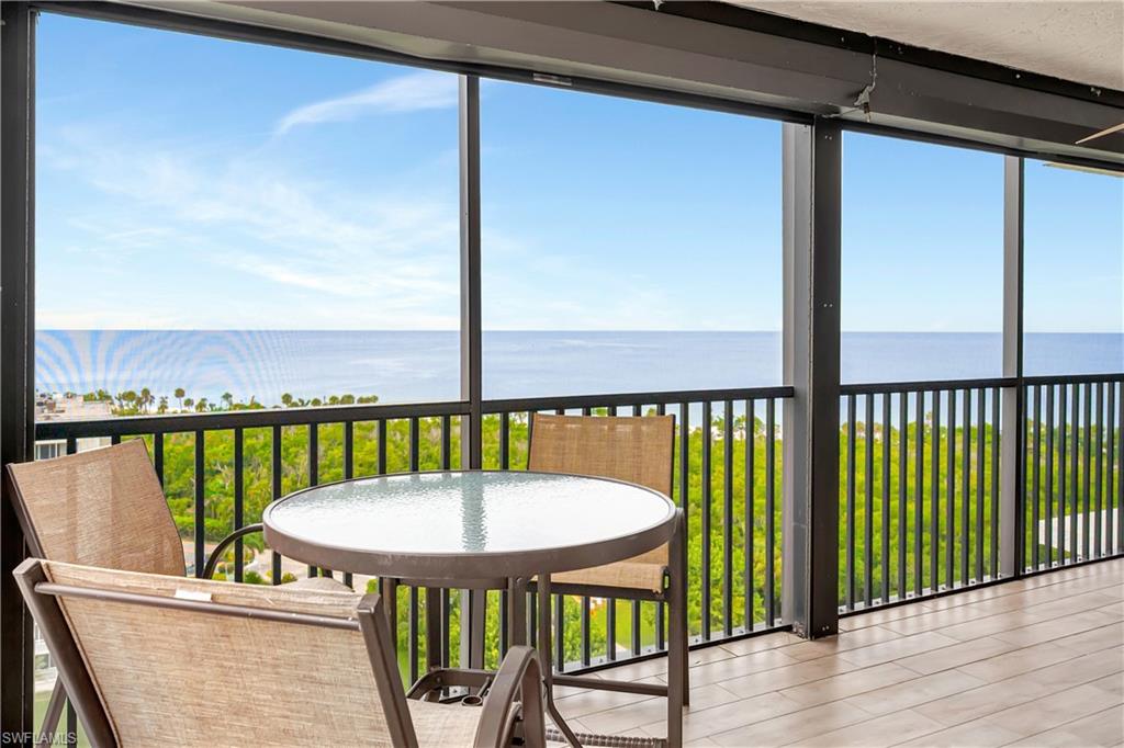 11 Bluebill Avenue, Unit 1101 Naples, FL 34108 - Photo 7 of 40 a view of a balcony with lake view and a wooden floor