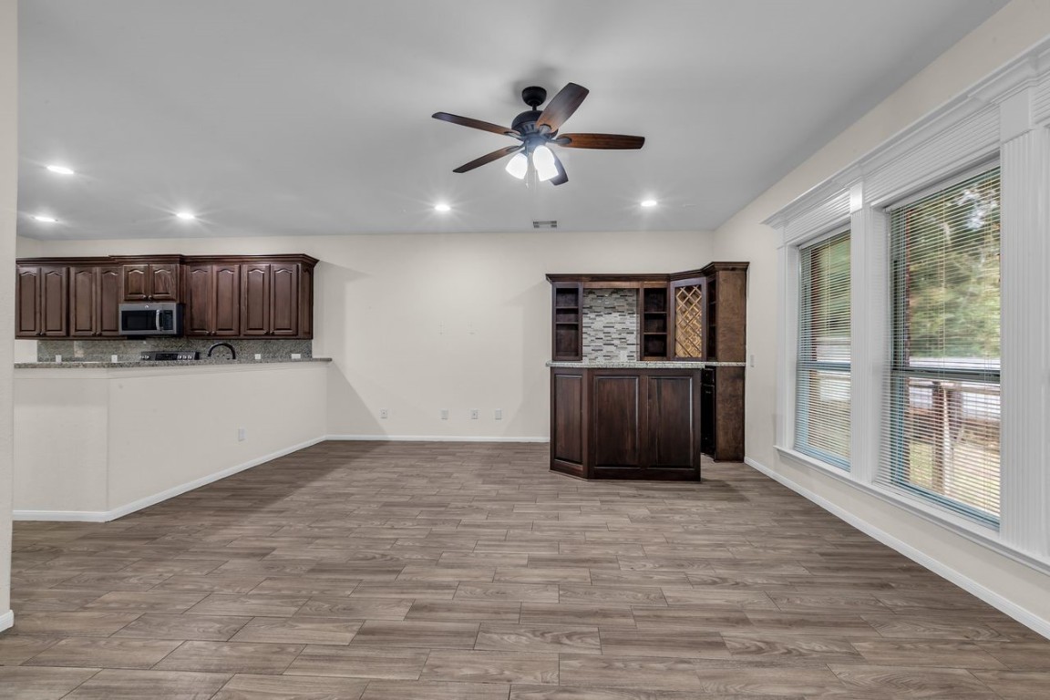 25171 Virginia Lane Porter, TX 77365 - Photo 18 of 39 a living room with stainless steel appliances kitchen island granite countertop a refrigerator and a stove top oven