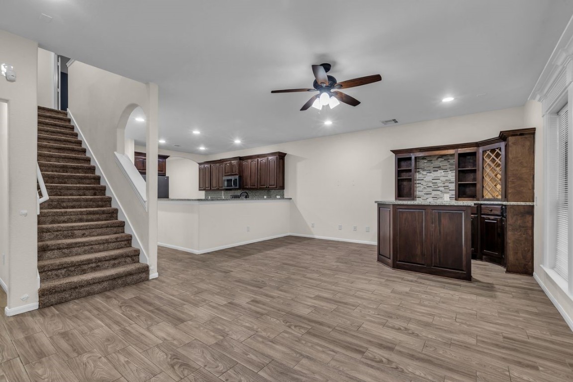 25171 Virginia Lane Porter, TX 77365 - Photo 19 of 39 a view of a livingroom with wooden floor and stairs