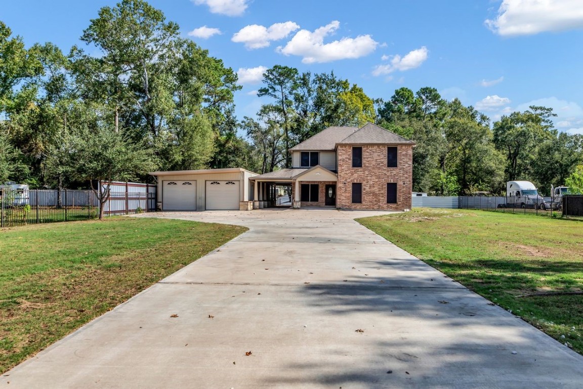 25171 Virginia Lane Porter, TX 77365 - Photo 2 of 39 a view of a house with a yard