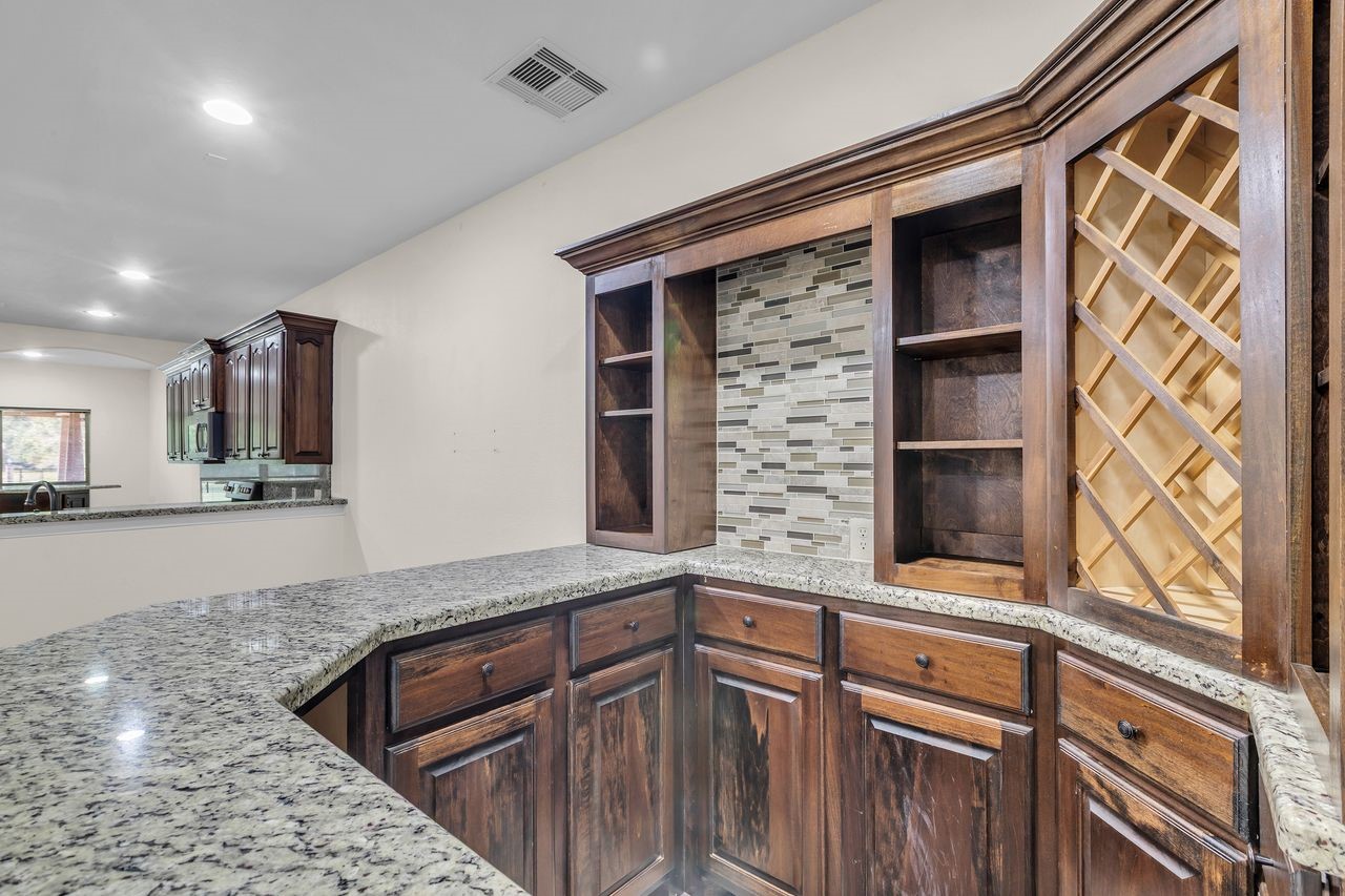 25171 Virginia Lane Porter, TX 77365 - Photo 21 of 39 a kitchen with stainless steel appliances granite countertop a sink and a microwave