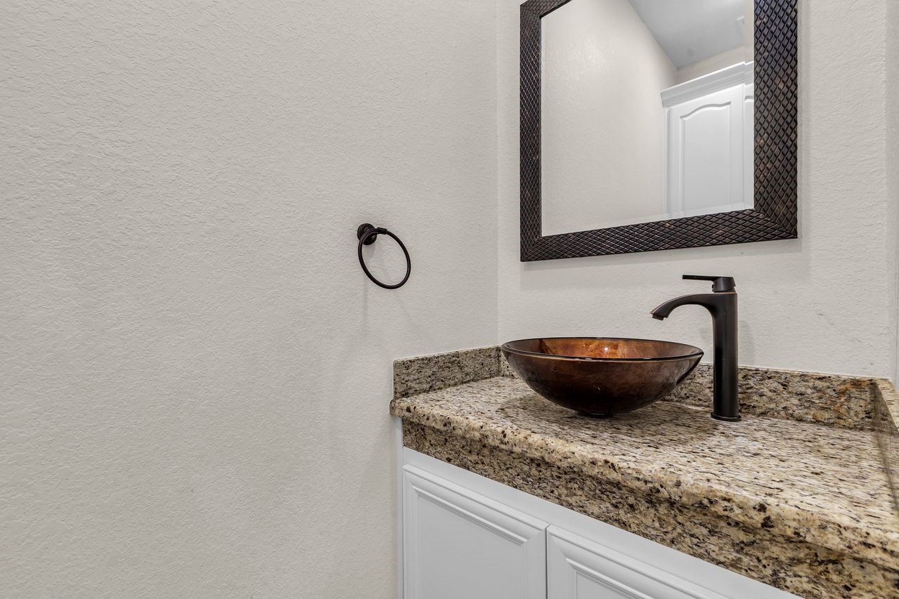 25171 Virginia Lane Porter, TX 77365 - Photo 23 of 39 a bathroom with a granite countertop sink and a mirror