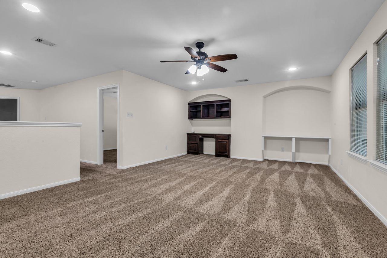 25171 Virginia Lane Porter, TX 77365 - Photo 31 of 39 a view of empty room with a kitchen and ceiling fan