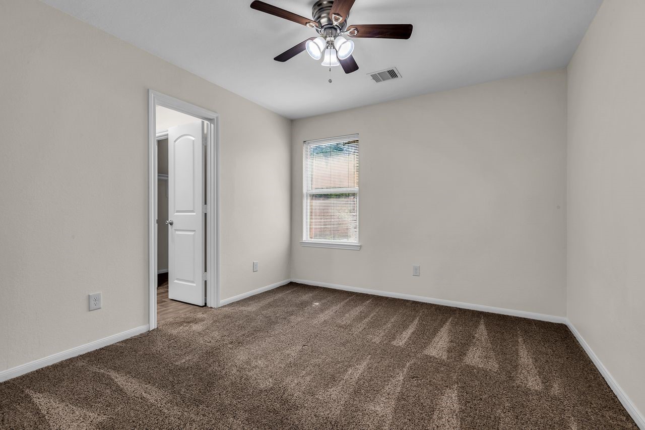 25171 Virginia Lane Porter, TX 77365 - Photo 32 of 39 an empty room with fan and windows