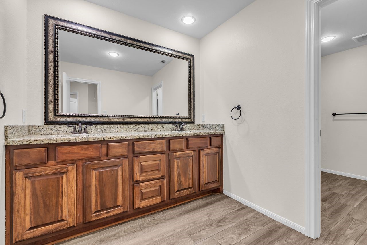 25171 Virginia Lane Porter, TX 77365 - Photo 35 of 39 a bathroom with a granite countertop sink and a mirror