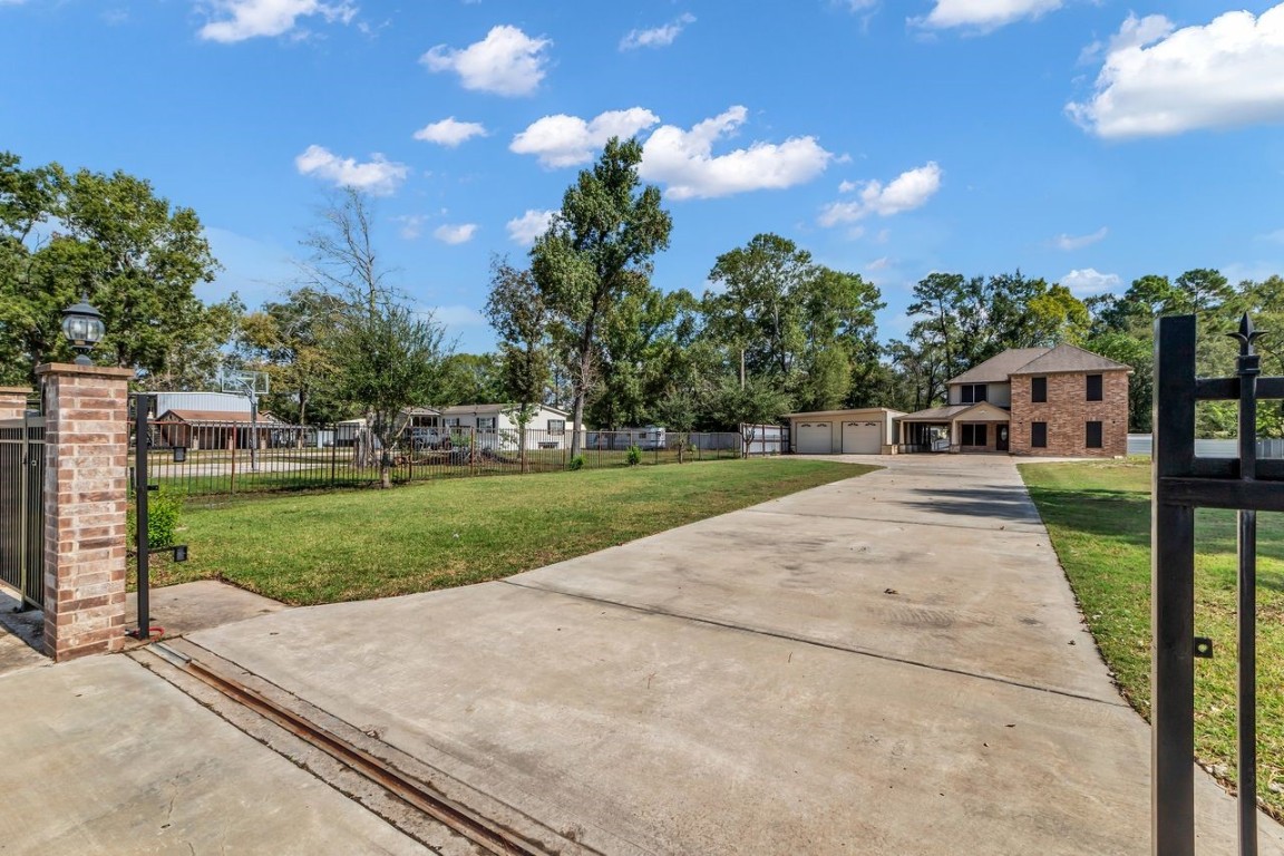 25171 Virginia Lane Porter, TX 77365 - Photo 5 of 39 a view of a house with a big yard plants and large trees