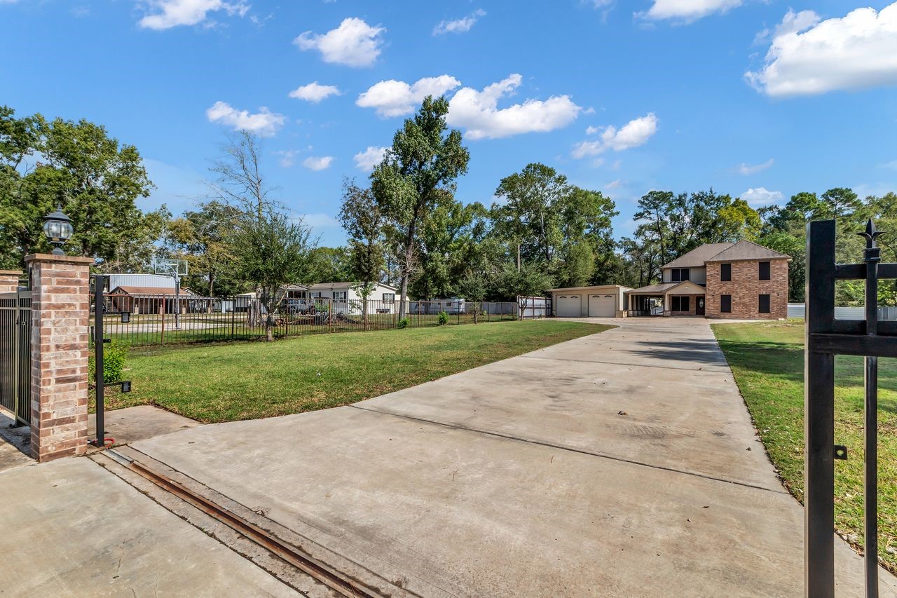 25171 Virginia Lane Porter, TX 77365 - Photo 5 of 39 a view of a house with a big yard plants and large trees
