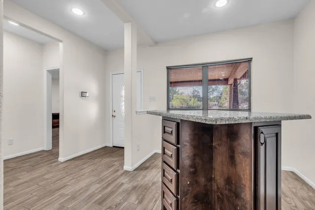 a room with wooden floor and a window