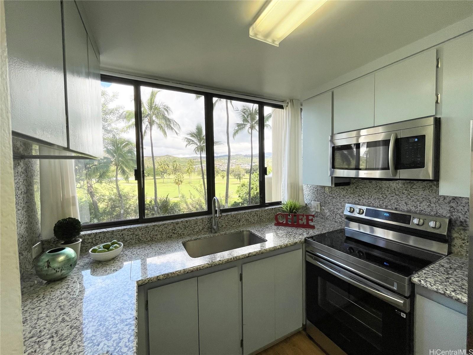 3050 Ala Poha Place, Unit W2 Honolulu, HI 96818 - Photo 1 of 25 a kitchen with a sink and appliances