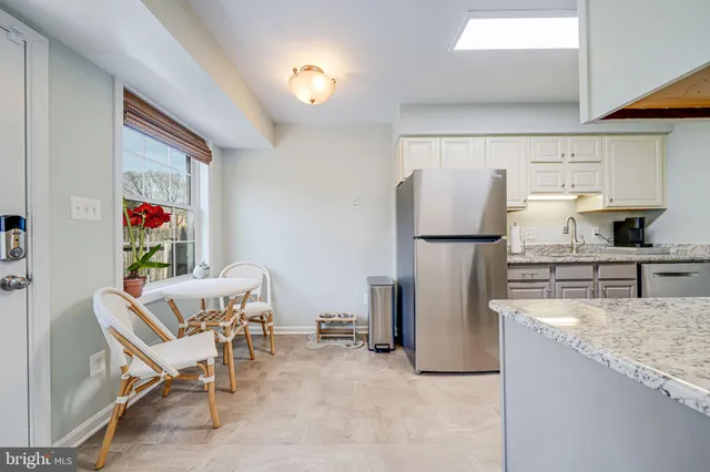 a view of a dining room with furniture a chandelier and wooden floor