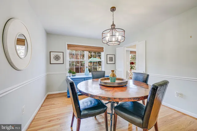 a view of a dining room with furniture wooden floor and chandelier