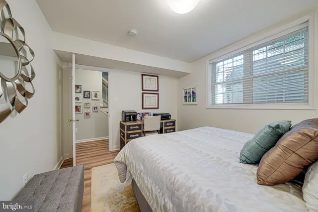 a living room with furniture a fireplace and a large window