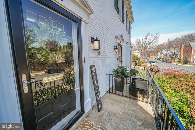 a view of a patio with couches chairs potted plants and a table