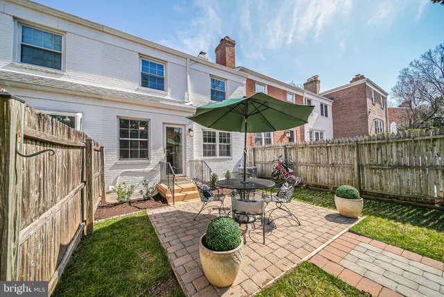 a view of a house with yard and sitting area