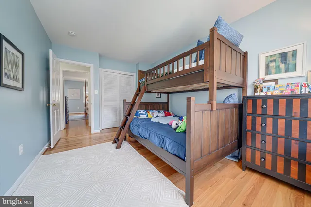 a bedroom with baby crib and a window