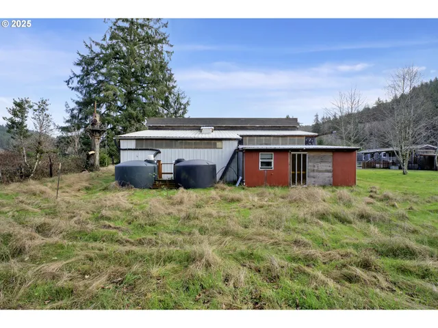 a view of a field of grass and trees