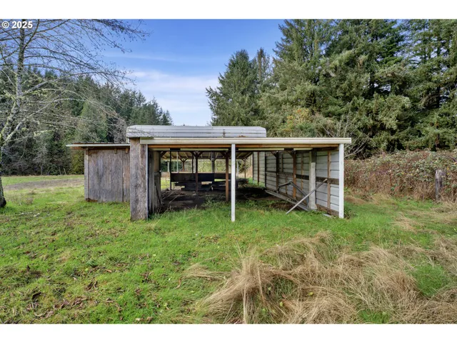 a view of a house with a yard and large trees