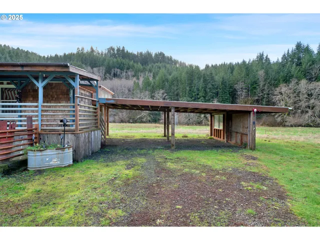 a view of a house with backyard and a wooden fence