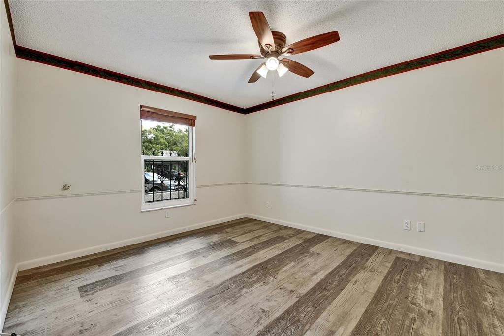 558 Capistrano Court Largo, FL 33771 - Photo 16 of 40 a view of a big room with wooden floor and windows