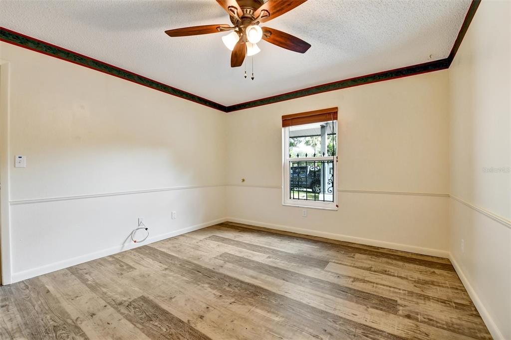 558 Capistrano Court Largo, FL 33771 - Photo 18 of 40 wooden floor in an empty room with a window