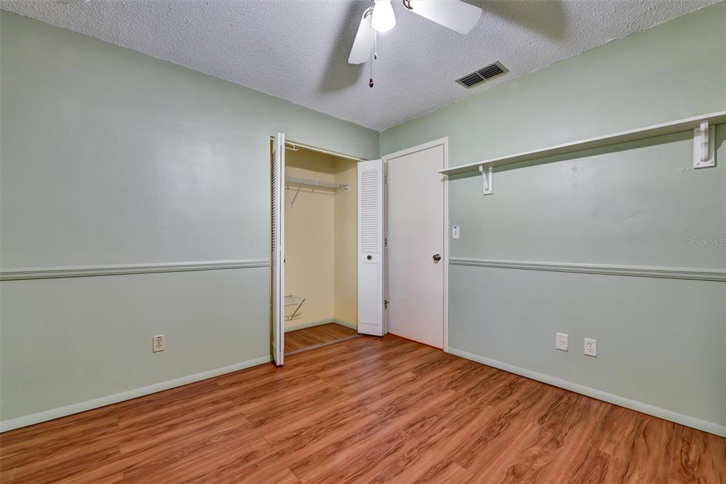 558 Capistrano Court Largo, FL 33771 - Photo 25 of 40 a view of empty room with wooden floor