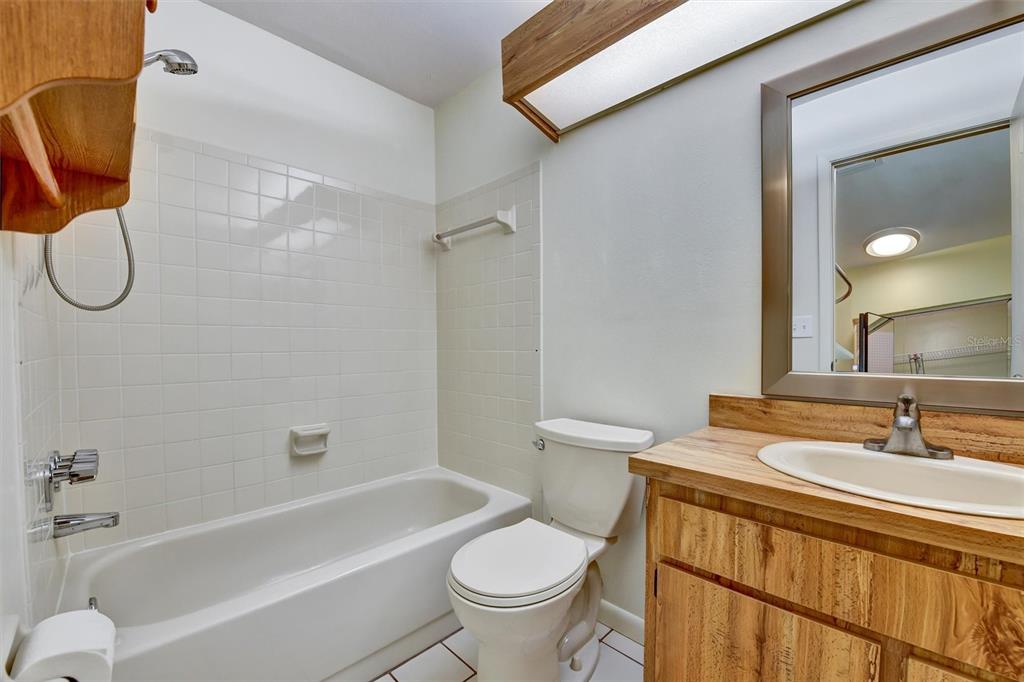 558 Capistrano Court Largo, FL 33771 - Photo 27 of 40 a bathroom with a sink a toilet and a bathtub