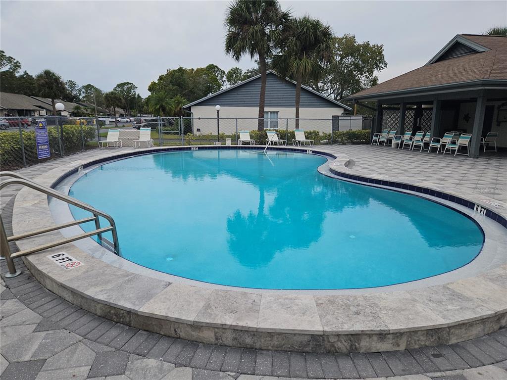 558 Capistrano Court Largo, FL 33771 - Photo 38 of 40 a view of a house with pool and chairs